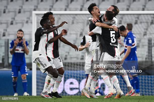 Juventus' Portuguese forward Cristiano Ronaldo celebrates with teammates after scoring during the Italian Serie A football match between Juventus and...