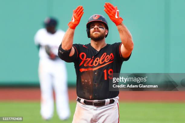 Chris Davis of the Baltimore Orioles reacts after hitting an RBI double in the ninth inning of a game against the Boston Red Sox at Fenway Park on...