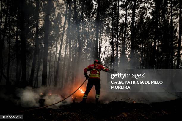 Firefighter tries to extinguish a wildfire in Vale da Cuba near Isna village, Castelo Branco, on July 26, 2020.