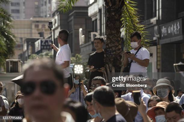 Onlookers gather to observe at a road block near the U.S. Consulate General in Chengdu, China, on Monday, July 27, 2020. The U.S. Lowered its flag...