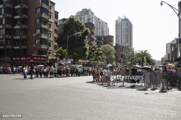 Onlookers gather to observe at a road block near the U.S. Consulate General in Chengdu, China, on Monday, July 27, 2020. The U.S. Lowered its flag...