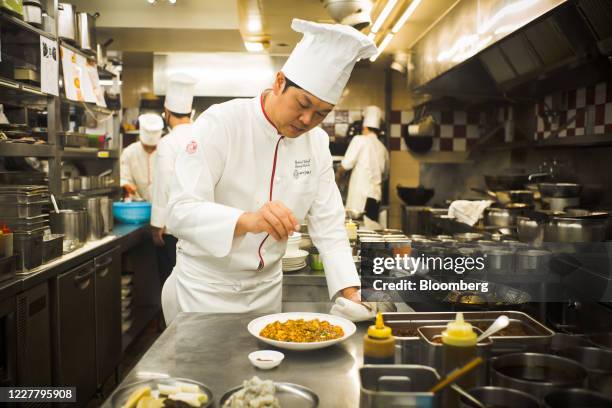 Kentaro Chen, celebrity chef at Shisen Hanten restaurant, prepares dishes at the restaurant's kitchen in Tokyo, Japan, on Friday, July 10, 2020....