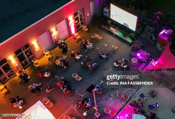 An aerial picture taken on July 26, 2020 shows visitors with their bicycles at a drive-in cinema for bicycles in Witten, western Germany, amid the...