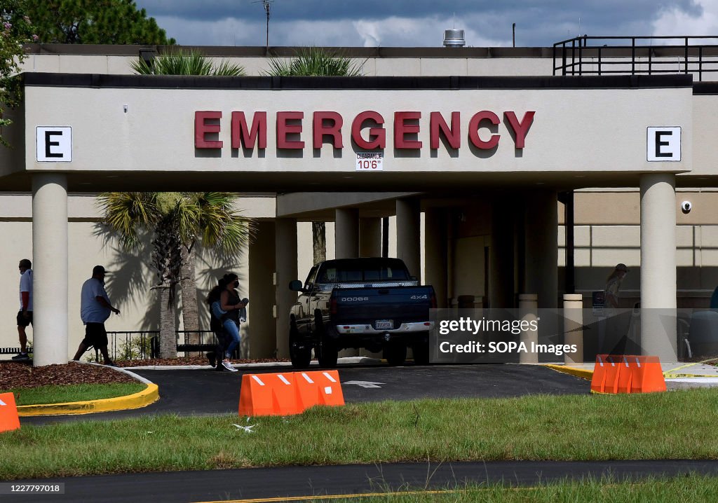People are seen outside the entrance to the emergency room...