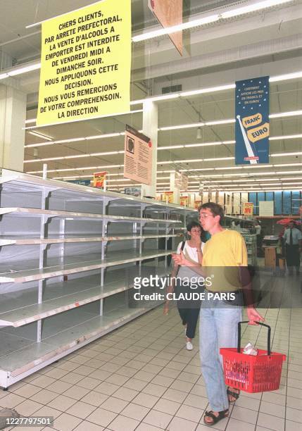 Les clients d'un supermarché de la périphérie de Marseille, constatent, le 19 juin, que le rayon de bière a été vidé par le personnel du magasin, en...