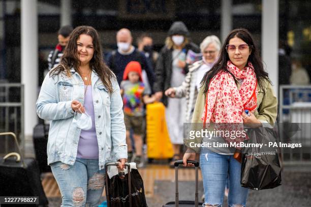 Aleksanda Sabalina and Edith Mikutenaite who live in Newtownabbey pictured leaving Belfast International Airport after arriving on Easyjet's 10am...