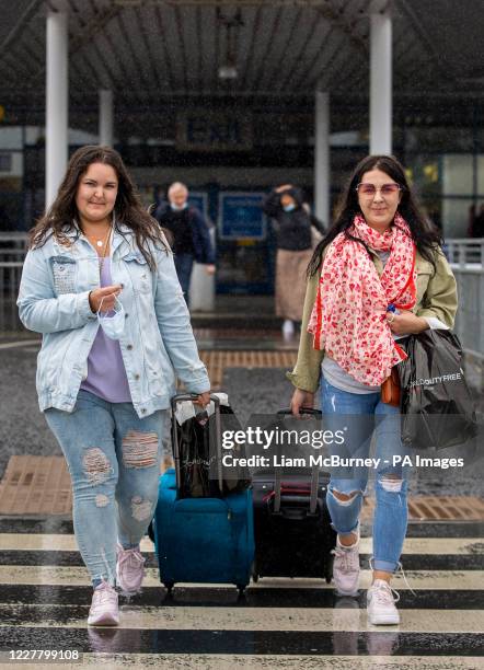 Aleksanda Sabalina and Edith Mikutenaite who live in Newtownabbey pictured leaving Belfast International Airport after arriving on Easyjet's 10am...