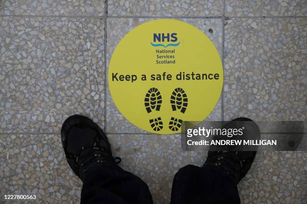 Sign advising visitors to social distance is pictured during a visit by Scotland's First Minister Nicola Sturgeon to the field hospital the NHS...