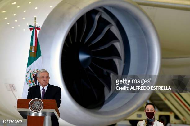 Mexican President Andres Manuel Lopez Obrador speaks during press conference, with the presidential plane in the background, at the presidential...