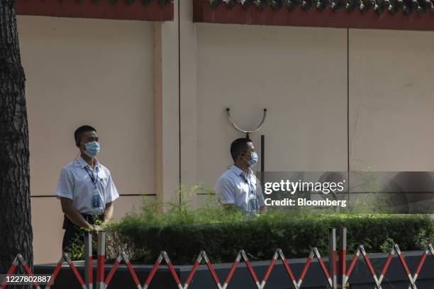 Security personnel stand guard outside the vacated U.S. Consulate General in Chengdu, China, on Monday, 27 July 2020. The closure of the U.S....