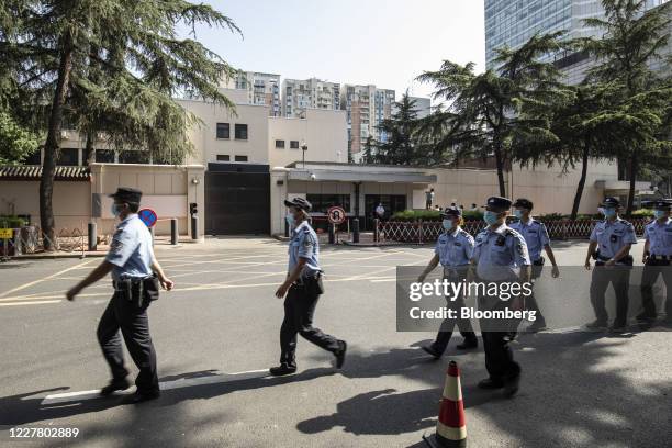 Police officer file past the vacated U.S. Consulate General in Chengdu, China, on Monday, 27 July 2020. The closure of the U.S. Consulate in Chengdu...