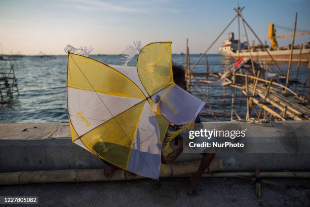 Kids prepares to fly a kite amid the spread of the coronavirus outbreak in Jakarta, Indonesia on July 27, 2020. According to The Indonesian...