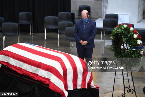 Senator Christopher Coons pays his respects as the flag-draped casket of the late Rep. John Lewis, D-Ga., lies in state at the Capitol Rotunda in...