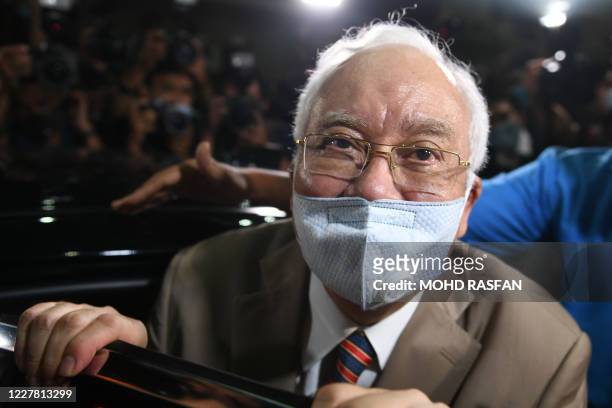 Malaysia's former prime minister Najib Razak gets into a car as he leaves the Duta Court complex after he was found guilty in his corruption trial in...