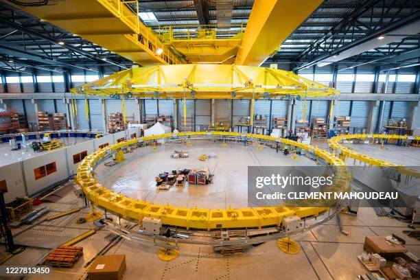 Technicians work in the winding facility for the construction of poloidal field coils which will be part of the magnetic system that will contribute...