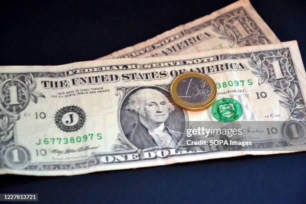 In this photo illustration, one euro coin placed on top of one dollar bills. The rise in the European currency accelerated following the approval of...