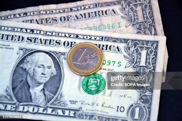 In this photo illustration, one euro coin placed on top of one dollar bills. The rise in the European currency accelerated following the approval of...