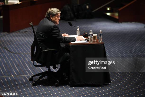 Attorney General William Barr reads from his opening statement before the House Oversight Committee on July 28, 2020 on Capitol Hill in Washington...