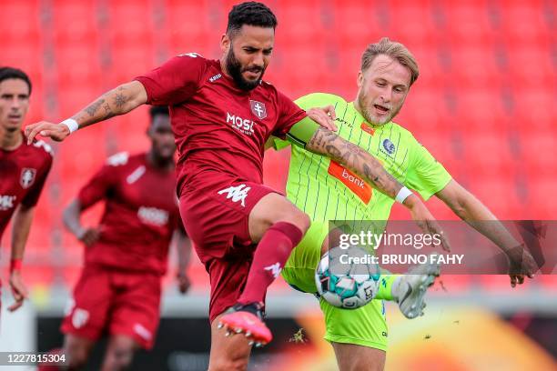 Metz' Tunisian defender Dylan Bronn vies with Gent's Ukrainian forward Roman Bezus during a friendly football match between Belgian first division...