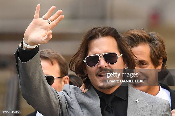 Actor Johnny Depp gestures as he leaves the Hight Court after the final day of his libel trial against News Group Newspapers , in London, on July 28,...