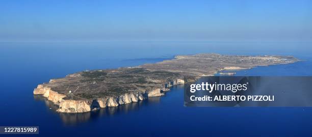 This aerial view taken on July 28 shows the Italian island of Lampedusa in the Meditteranean Sea, which in recent years has been an arrival point for...