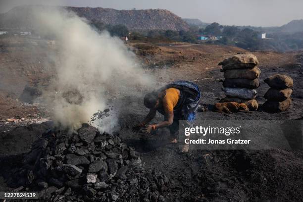 Villagers living around the coal mines in Dhanbad burns coal into pieces of coke, that is sold on the markets as a hot-burning fuel that families can...