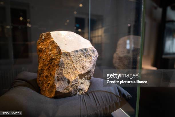 July 2020, Baden-Wuerttemberg, Blaubeuren: The largest stone meteorite in Germany is in a display case in the Prehistoric Museum. The find will be on...