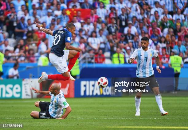 Kylian Mbappe of France jumping over Javier Mascherano of Argentina during the FIFA World Cup match France versus Argentina at Kazan Arena, Kazan,...