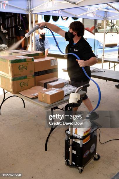 Employee sanitizes packages delivered to the warehouse at Coronado Springs as part of the NBA Restart 2020 on July 27, 2020 in Orlando, Florida. NOTE...