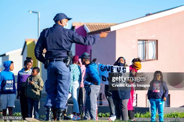 Residents demonstrate along the Duinefontein Road during a large scale protest action in the Cape organised by the group Gatvol Capetonian on July...