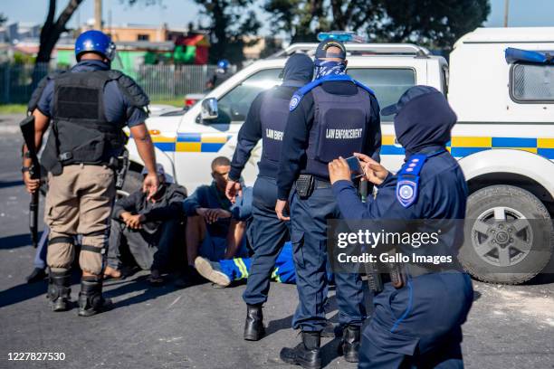Law enforcement officers during a large scale protest action organised by the group Gatvol Capetonian on July 27, 2020 in Cape Town, South Africa. It...