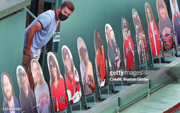 Man checks out the scene on the Green Monster where the cardboard cutout fans are placed in seats during batting practice. The Boston Red Sox host...