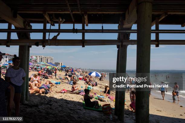 Beachgoers at Old Orchard Beach on Sunday, July 19, 2020. The beach was filled by late morning as temperatures reached into the upper 80s.