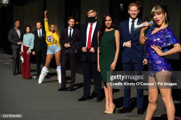 Wax figures, including Taylor Swift, the Duke and Duchess of Sussex, US President Donald Trump and Eddie Redmayne, in the entrance line at Madame...