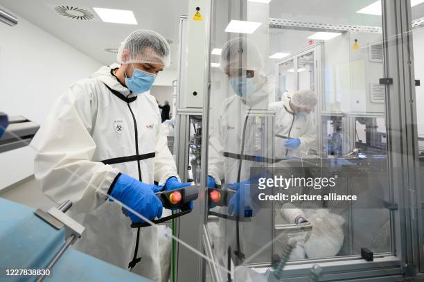 July 2020, Saxony, Ohorn: An employee of PHB Pulsnitzer Hygiene Berufsbekleidung GmbH controls the production of disposable masks. The company from...