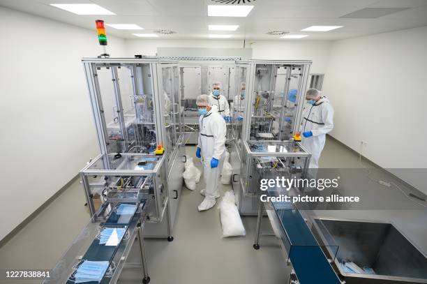 July 2020, Saxony, Ohorn: Employees of PHB Pulsnitzer Hygiene Berufsbekleidung GmbH are involved in the production of disposable masks. The company...