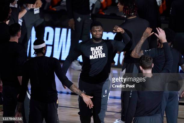 Zion Williamson of the New Orleans Pelicans wears a Black Lives Matter shirt as he is introduced before the start of an NBA basketball game against...
