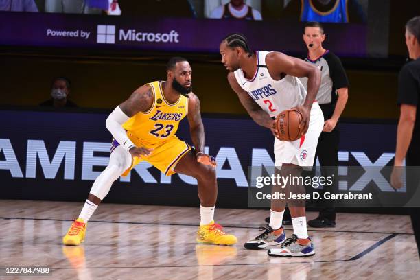 Orlando, FL LeBron James of the Los Angeles Lakers plays defense against Kawhi Leonard of the LA Clippers on July 30, 2020 at The Arena at ESPN Wide...