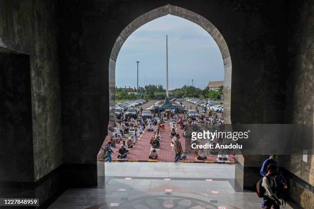 Muslims in Indonesia perform praying Eid al- Adha using face masks and maintaining physical distance amid coronavirus outbreak at An-Nur Grand Mosque...