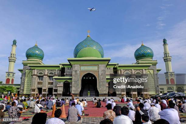 Muslims in Indonesia perform praying Eid al- Adha using face masks and maintaining physical distance amid coronavirus outbreak at An-Nur Grand Mosque...