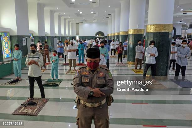 Muslims in Indonesia perform praying Eid al- Adha using face masks and maintaining physical distance amid coronavirus outbreak at An-Nur Grand Mosque...