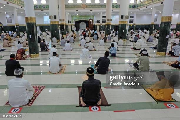 Muslims in Indonesia perform praying Eid al- Adha using face masks and maintaining physical distance amid coronavirus outbreak at An-Nur Grand Mosque...