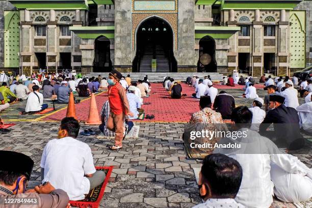 Muslims in Indonesia perform praying Eid al- Adha using face masks and maintaining physical distance amid coronavirus outbreak at An-Nur Grand Mosque...