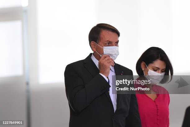 Brazil's president Jair Bolsonaro next to first Lady Michelle Bolsonaro arrive to attend the launching ceremony of a campaign to support rural women...