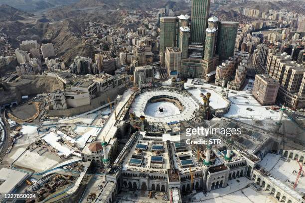 An aerial view taken on July 31, 2020 shows pilgrims circumambulating around the Kaaba, the holiest shrine in the Grand mosque in the holy Saudi city...