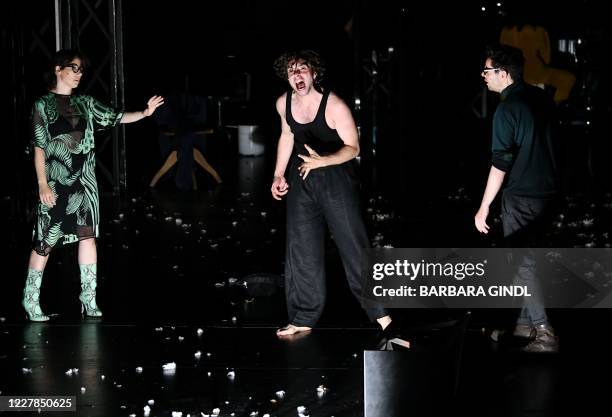 This picture taken on July 30, 2020 in Salzburg, Austria, shows actors Eva Loebau, Andre Kaczmarczyk and Christian Friedel during a dress rehearsal...