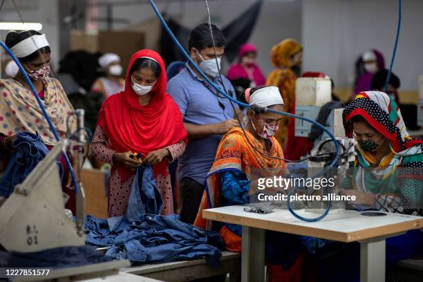 July 2020, Bangladesh, Dhaka: Women work in a textile factory. Bangladesh is the second largest producer of textiles after China. The working...