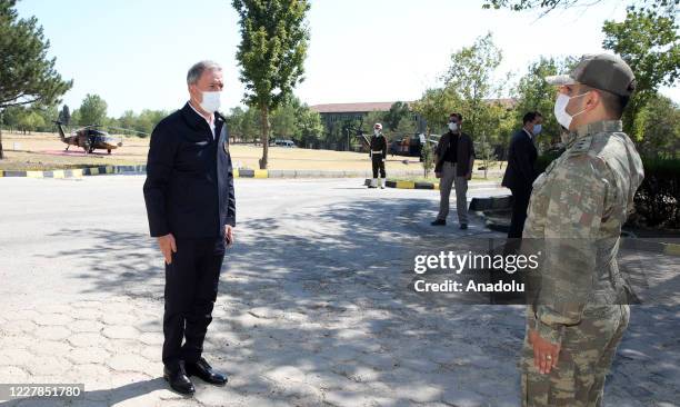 Turkish Defense Minister Hulusi Akar greets soldiers with Turkish Chief of General Staff Gen. Yasar Guler, Turkish Land Forces Commander Gen. Umit...