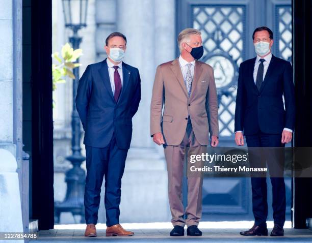 Leader of the New Flemish Alliance Bart De Wever and the Leader of the Socialist Party Paul Magnette are welcome by the King of the Belgians Philippe...