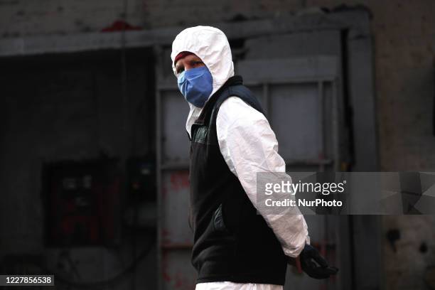 Worker of a car wash carry out their tasks using face masks as a preventive measure in Buenos Aires, Argentina, on July 31, 2020. After more than...